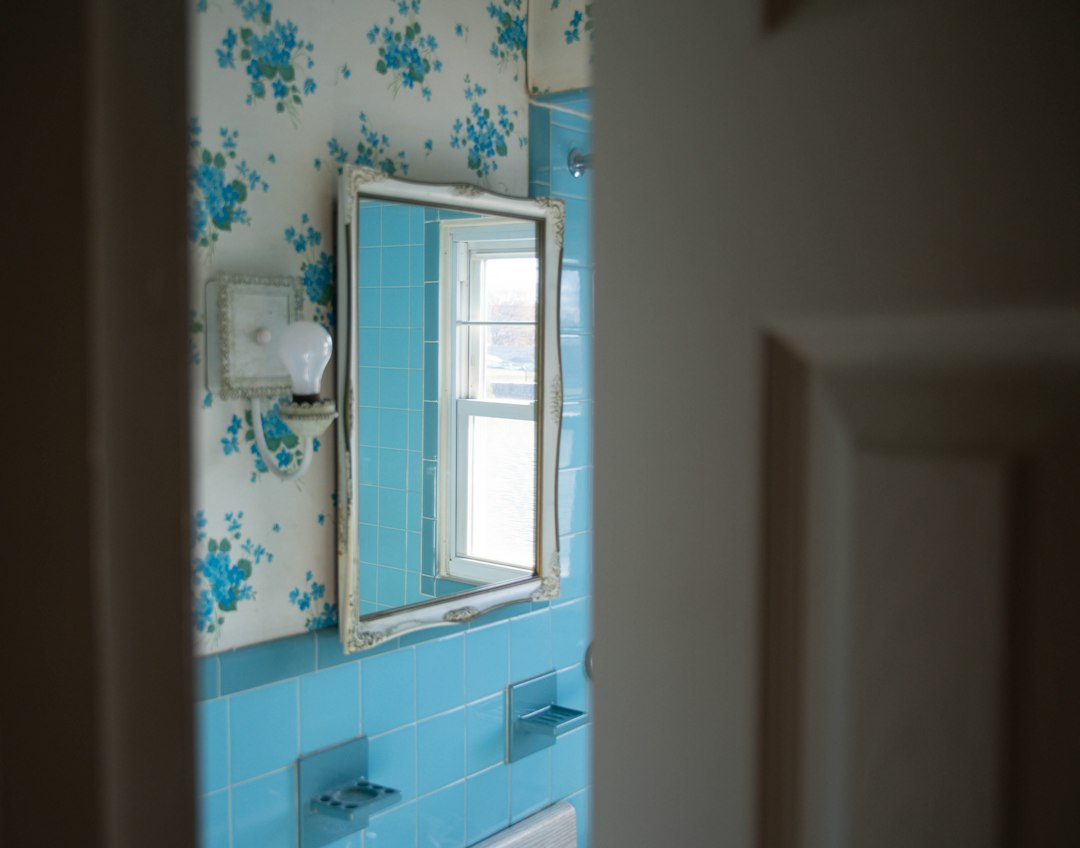 Bathroom seen through a partly open door showing door size