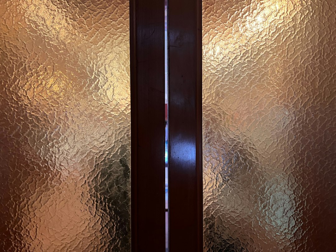 Fluted glass panels in a dark aluminium door frame