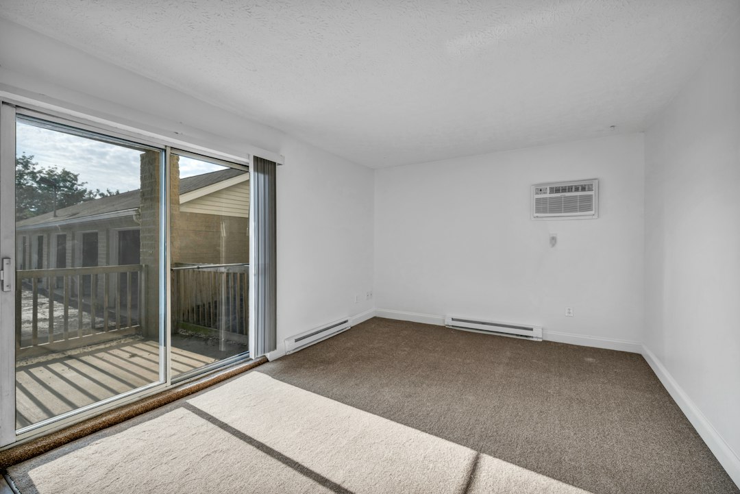 Living room with sliding glass opening to a balcony